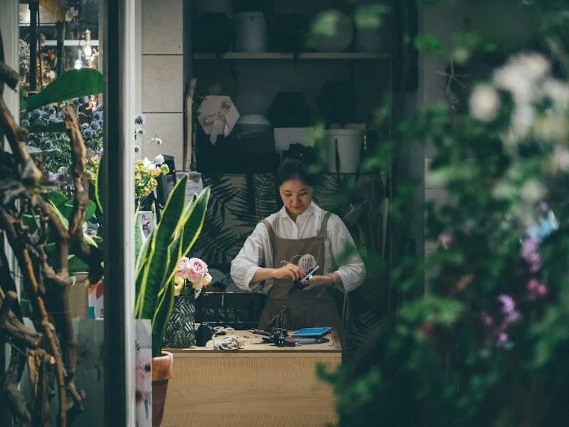 A florist arranging flowers in a shop.